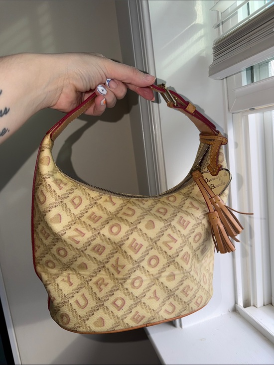 Dooney & Bourke Handbags - Dooney & Bourke vintage YTK Beige Canvas Hobo with Red Trim and Tan Tassel